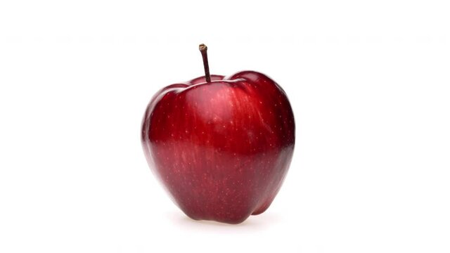 Whole red apple fruit isolated. Rotating on white background. Closeup.