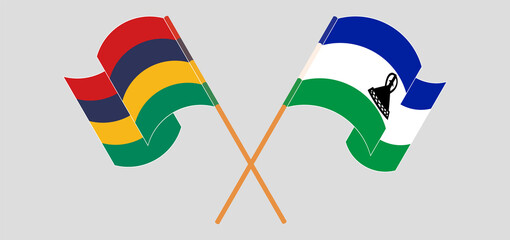 Crossed and waving flags of Mauritius and Kingdom of Lesotho