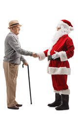 Elderly man and santa claus shaking hands