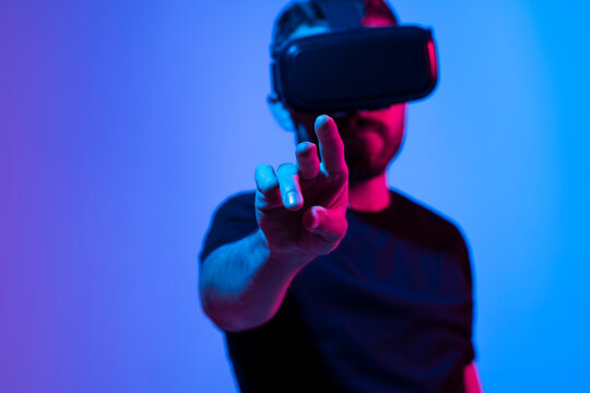 Future Technology and Business Concept. The man with glasses of virtual reality touching something in a virtual space.