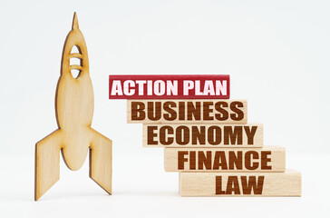 On the white surface there is a wooden rocket and planks, on the red plaque the inscription - ACTION PLAN