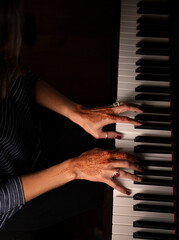 Woman's hands playing the piano 