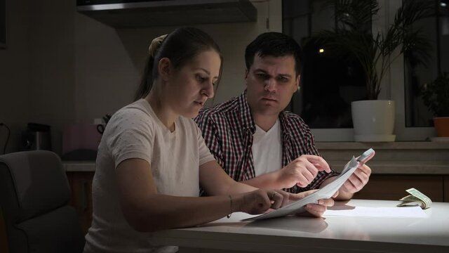 Stressed couple having no money to pay taxes, monthly payment or house loan. Concept of financial difficulties, poverty, bankruptcy, taxes and rent payment.