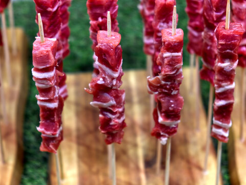 wooden plank with the traditional -arrosticini abbruzzesi-: skewers of sheep meat