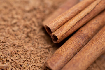 Macro shot of cinnamon powder and some sticks. Aromatic natural spices