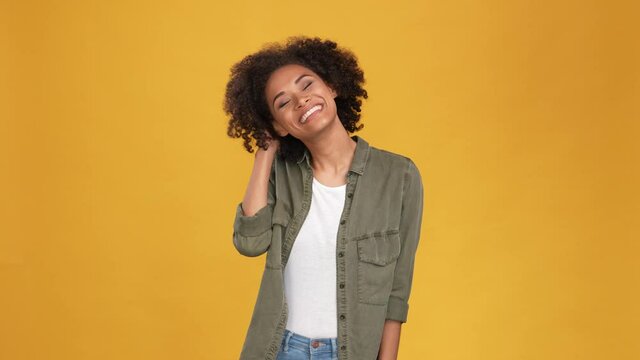 Charming lady touch curls dander lotion use isolated mustard color background