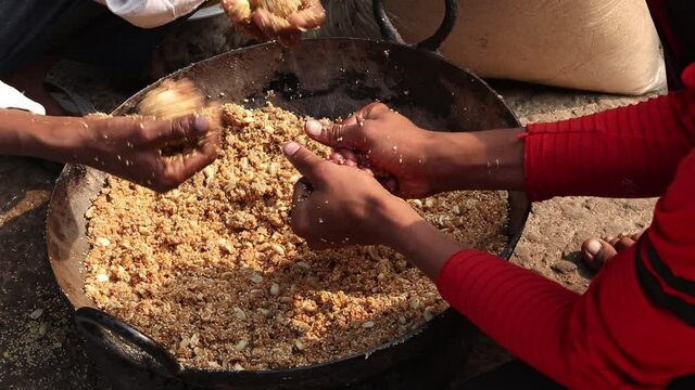Rolling Roasted Sesame Seeds, Dry Fruits Kaju Badam Moonfali Mawa Malai Mungfali Nuts Mava With Hands To Make Mithai Gajjak Til Gul Gajak Laddu Or Tilgul Gazak Ladoo For Makar Sankranti And Lohri
