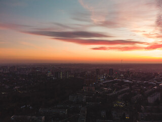 Aerial scenic vivid sunset view with epic skyscape. Kharkiv city center, Pavlove pole residential district streets in evening light