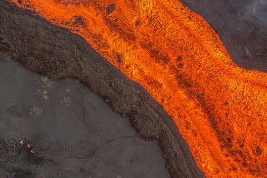 Aerial top down view of lava floating down the Volcan Cumbre Vieja, a volcano during eruption near El Paraiso town, Las Manchas, La Palma Island, Canary Islands, Spain.