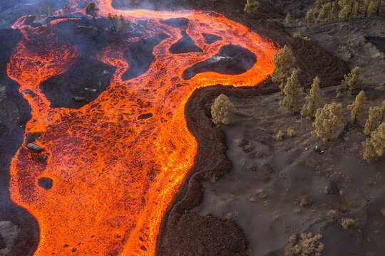 Aerial top down view of lava floating down the Volcan Cumbre Vieja, a volcano during eruption near El Paraiso town, Las Manchas, La Palma Island, Canary Islands, Spain.