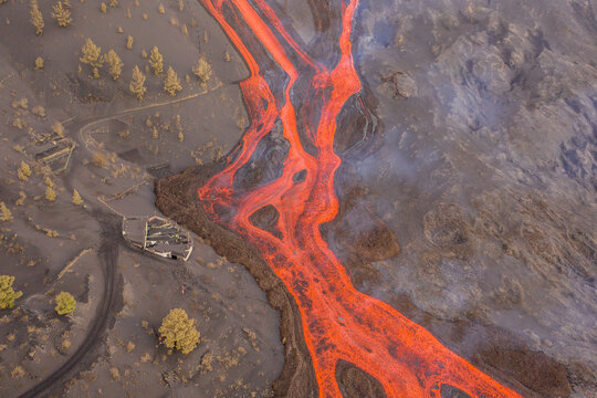 Aerial top down view of lava floating down the Volcan Cumbre Vieja, a volcano during eruption near El Paraiso town, Las Manchas, La Palma Island, Canary Islands, Spain.