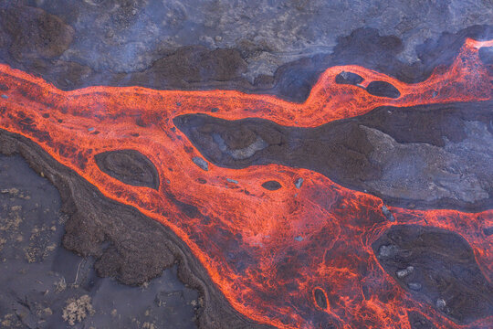 Aerial top down view of lava floating down the Volcan Cumbre Vieja, a volcano during eruption near El Paraiso town, Las Manchas, La Palma Island, Canary Islands, Spain.