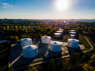 Fototapeta na wymiar Petrol industrial zone. Aerial view of round tanks