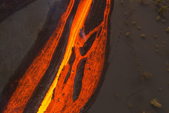 Aerial top down view of lava floating down the Volcan Cumbre Vieja, a volcano during eruption near El Paraiso town, Las Manchas, La Palma Island, Canary Islands, Spain.