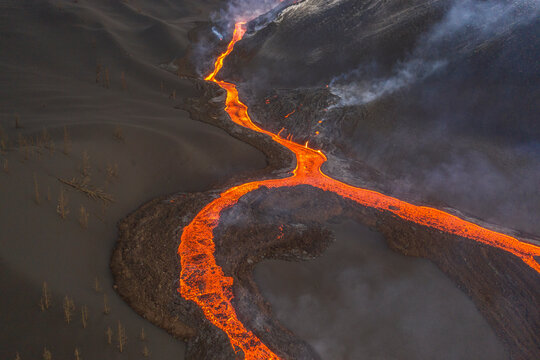 Aerial top down view of lava floating down the Volcan Cumbre Vieja, a volcano during eruption near El Paraiso town, Las Manchas, La Palma Island, Canary Islands, Spain.