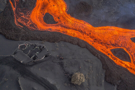 Aerial top down view of lava floating down the Volcan Cumbre Vieja, a volcano during eruption near El Paraiso town, Las Manchas, La Palma Island, Canary Islands, Spain.