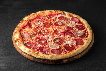 Pizza on a fluffy dough on a black background