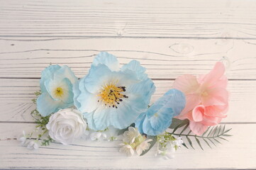 Light Blue White and Light Coral Flowers Green Leaves on White Paneling as Backup