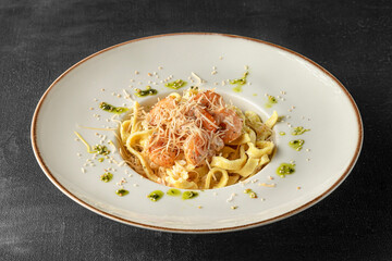 Pasta in a white plate on a black background