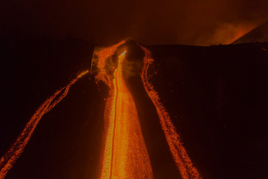 Aerial top down view of lava floating down the Volcan Cumbre Vieja at night, a volcano during eruption near El Paraiso town, Las Manchas, La Palma Island, Canary Islands, Spain.