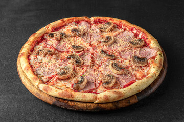 Pizza on a fluffy dough on a black background
