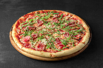 Pizza on a fluffy dough on a black background