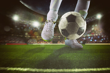 Close up of a soccer scene with player kicking the ball at the stadium - obrazy, fototapety, plakaty
