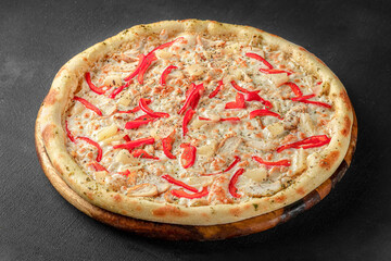 Pizza on a fluffy dough on a black background