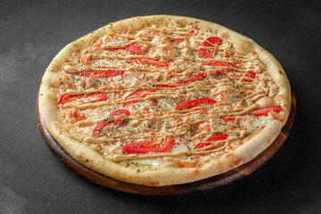 Pizza on a fluffy dough on a black background