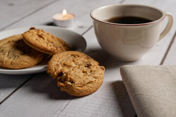 Nut biscuits and a coffee cup on a gray wooden table.