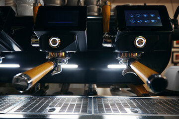 Close up photo of espresso machine with bar interior background