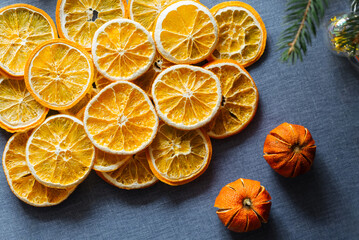 Fototapeta na wymiar Dried oranges on blue background. Top view. Cozy winter decoration. 