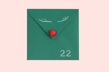 Merry Christmas happy New Year concept. Greeting card and congratulations, 25, red nose and eyes as Christmas decorations on green letter for advent calendar. Top view, flat lay.