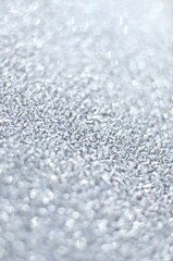 Natural background with transparent ice crystals of hoarfrost formed on the surface in the early morning. Can be used as a vertical winter texture with copy space. Very short depth of field.
