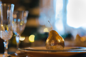 festive gold pear decoration on fancy table scene. christmas holiday