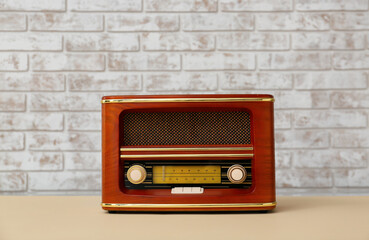 Vintage radio receiver on table in room