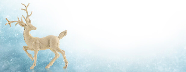 Christmas symbol, deer, toy reindeer on abstract blue background.