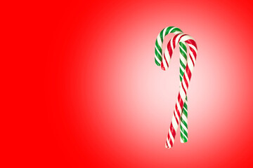 Christmas candy cane, two christmas symbols on red background.