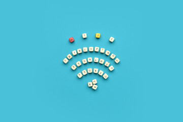 Little wooden cubes with word WiFi and different letters on blue background