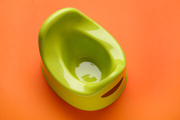 Modern green potty on color background