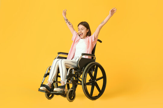 Happy Young Woman In Wheelchair On Color Background