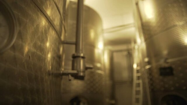 Large stainless steel wine distilling tanks. Silos for wine or beer fermentation. Slow Motion 100 fps