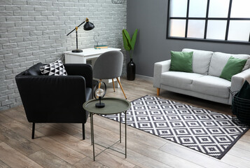 interior of modern living room with black armchair, grey sofa and workplace