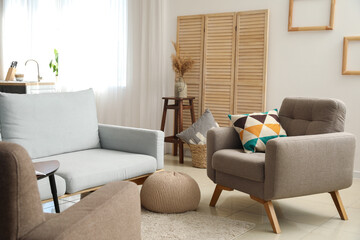 Stylish interior of modern room with sofa and armchair