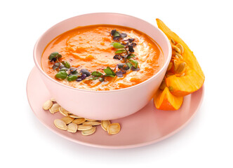 Bowl with delicious pumpkin cream soup and seeds on white background