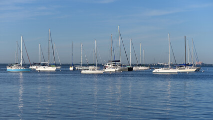 Sailboats at anchor off Crandon Park and marina on sunny autumn morning.