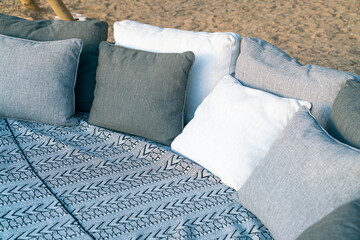 pillows on outdoor patio deck chair on beach with sunset times