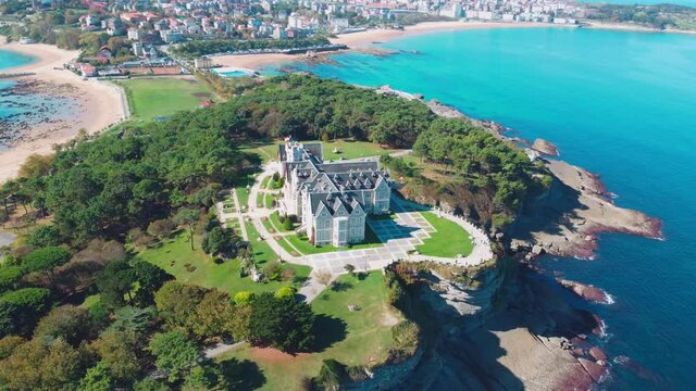 A beautiful peninsula surrounded by the blue sea and sandy beaches. Aerial view of Magdalena Palace in Santander, Cantabria Spain