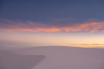 Fototapeta na wymiar White Dunes Fade Into The Sky At Sunset