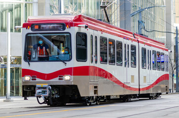 Naklejka na ściany i meble Passengers light rail transit train in downtown